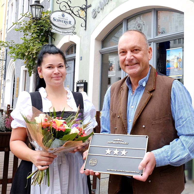 Leiter Gastronomie Meißen, André Kreuziger, präsentiert die 3-Stern-Auszeichnung für das Schwerter Schankhaus & Hotel